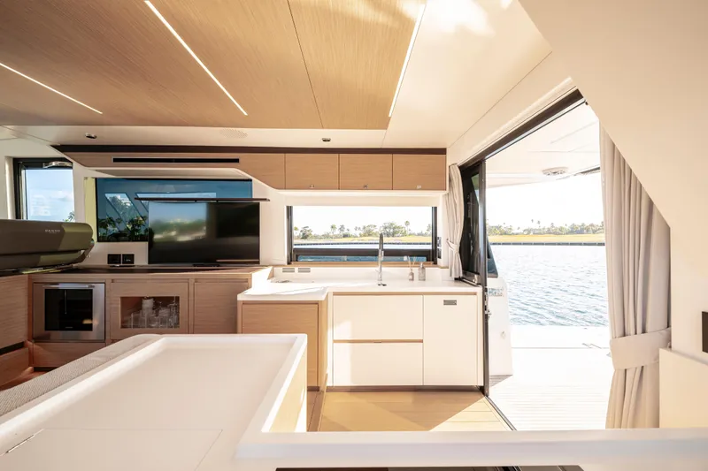Slide: The Image of Luxurious interior of 2023 Pardo Yachts E60, featuring modern kitchen and elegant wood finishes. - 27