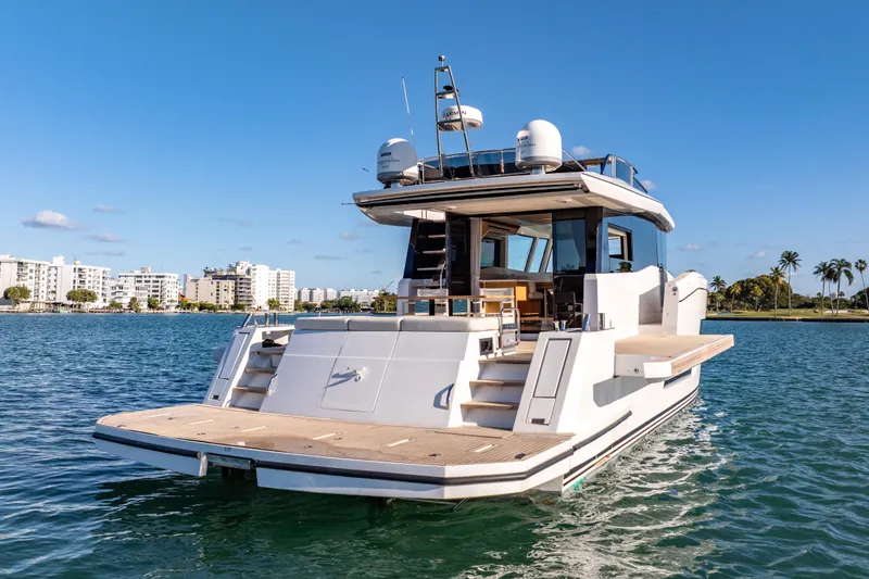 Slide: The Image of 2023 Pardo Yachts E60 luxury yacht on serene blue water. - 5