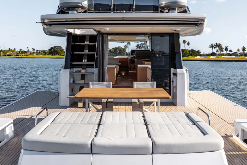 Slide: The Image of 2023 Pardo Yachts E60 luxury yacht on calm water, cityscape in background. - 6