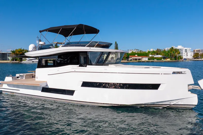 Slide: The Image of Luxury 2023 Pardo Yachts E60 on serene blue water, clear sky backdrop. - 16