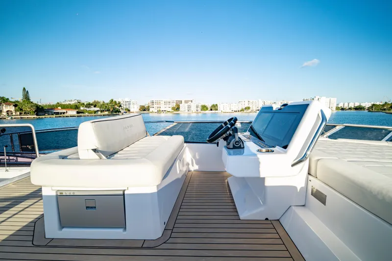Slide: The Image of Luxurious 2023 Pardo Yachts E60 deck with seating and table, overlooking serene water. - 56