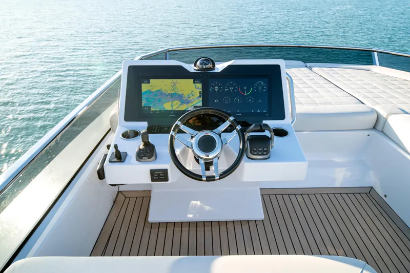 Slide: The Image of 2023 Pardo Yachts E60 helm station with luxurious seating and waterfront view. - 57