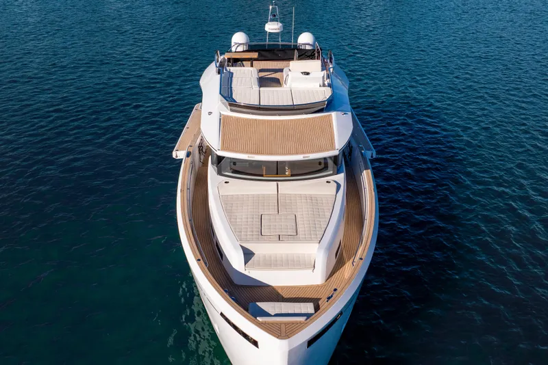 Slide: The Image of 2023 Pardo Yachts E60 cruising on water near luxury waterfront homes. - 61