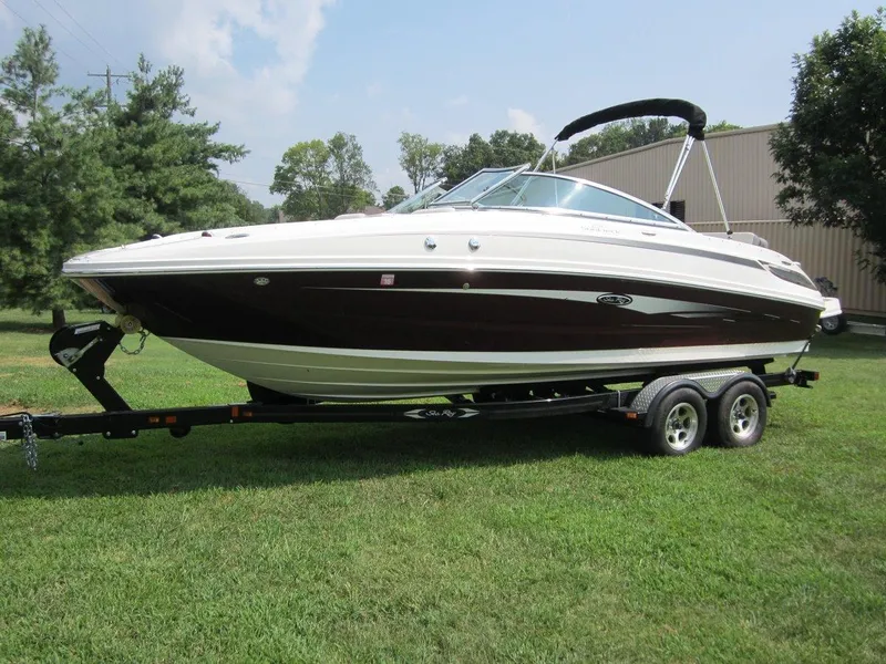 The Image of 2012 Sea Ray 240 Sundeck boat on trailer outdoors. - 0