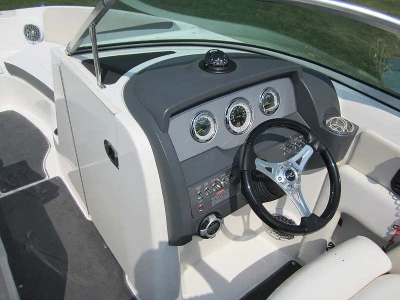 Slide: The Image of Interior view of 2012 Sea Ray 240 Sundeck cockpit. - 17