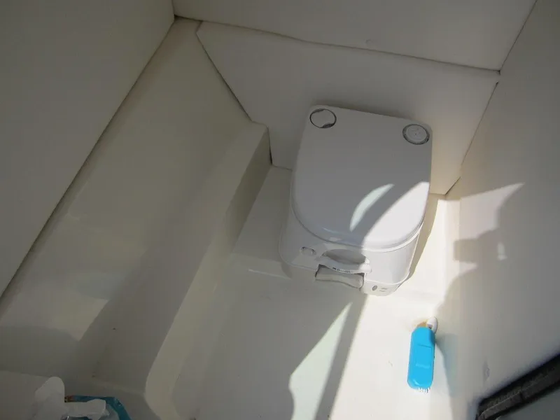 Slide: The Image of Interior of 2012 Sea Ray 240 Sundeck with toilet. - 19
