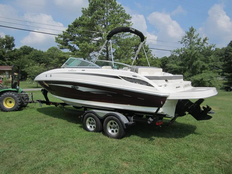Slide: The Image of 2012 Sea Ray 240 Sundeck on trailer outdoors. - 2