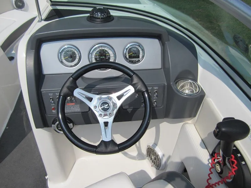 Slide: The Image of Steering wheel and dashboard of a 2012 Sea Ray 240 Sundeck boat. - 20