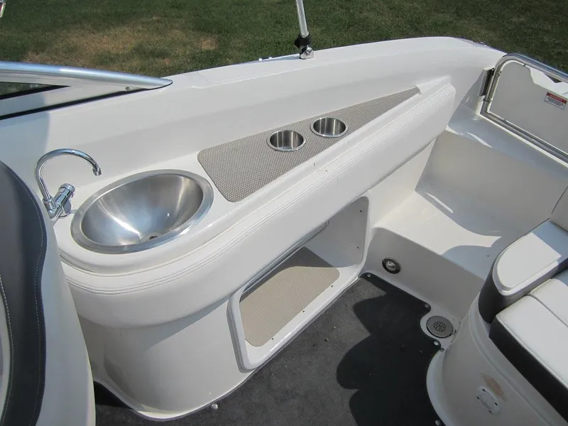 Slide: The Image of Interior view of 2012 Sea Ray 240 Sundeck with sink and cup holders. - 26