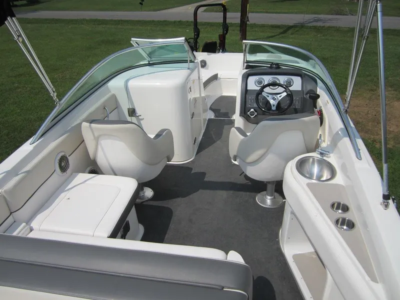 Slide: The Image of Interior of a 2012 Sea Ray 240 Sundeck boat with seating and helm. - 28