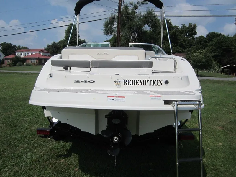Slide: The Image of Rear view of a 2012 Sea Ray 240 Sundeck boat on grass. - 30