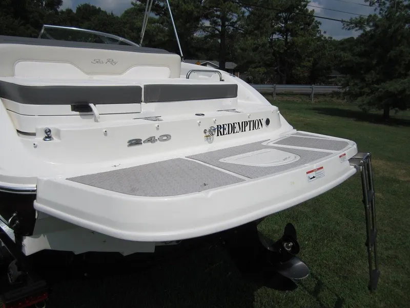 Slide: The Image of Rear view of a 2012 Sea Ray 240 Sundeck boat on grass. - 31