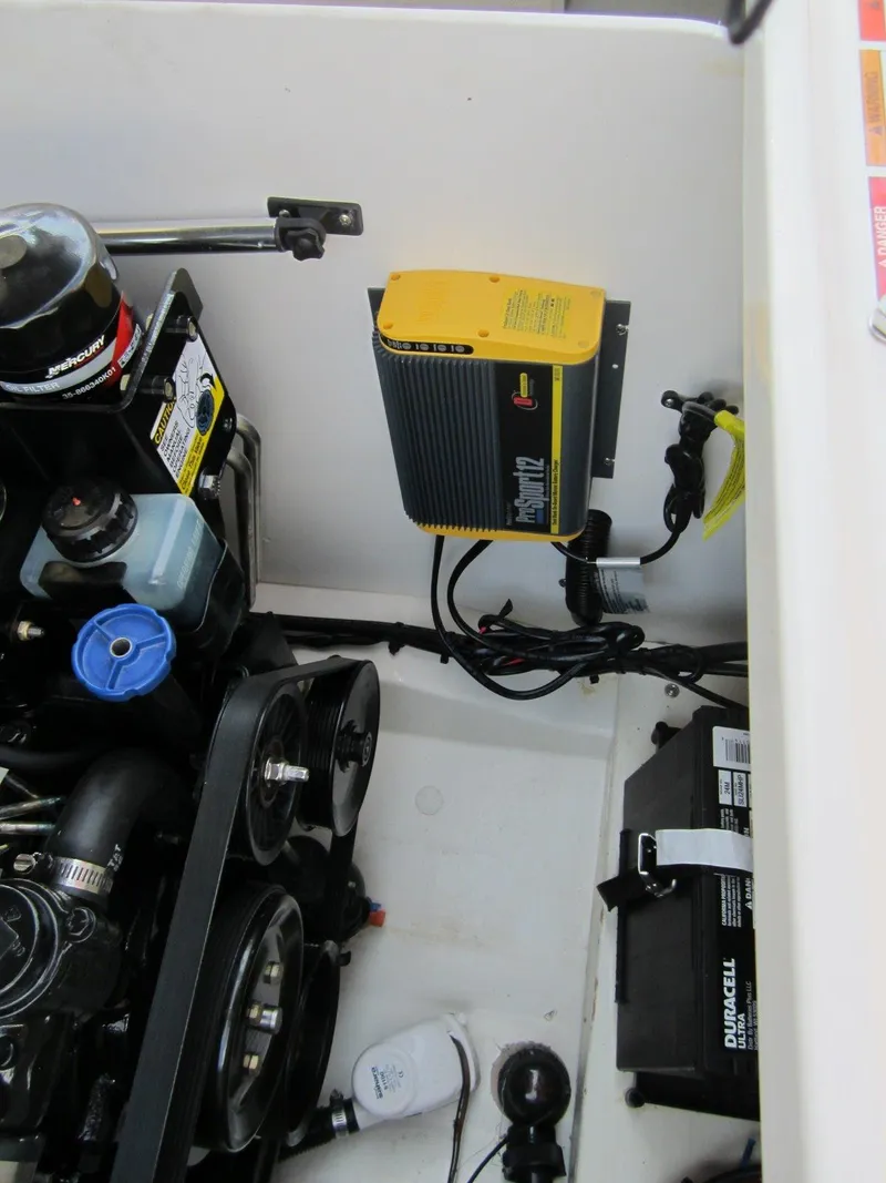 Slide: The Image of Engine compartment of 2012 Sea Ray 240 Sundeck with battery and charger. - 35