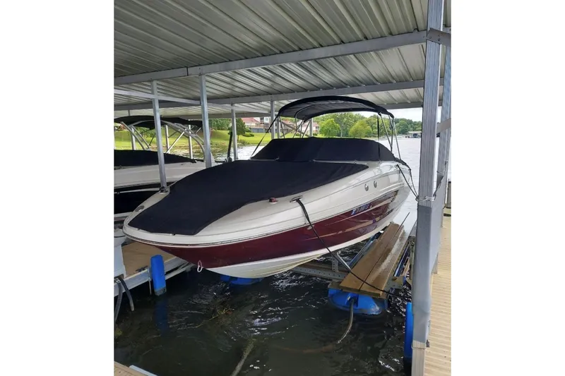 Slide: The Image of 2012 Sea Ray 240 Sundeck boat covered at dock. - 39