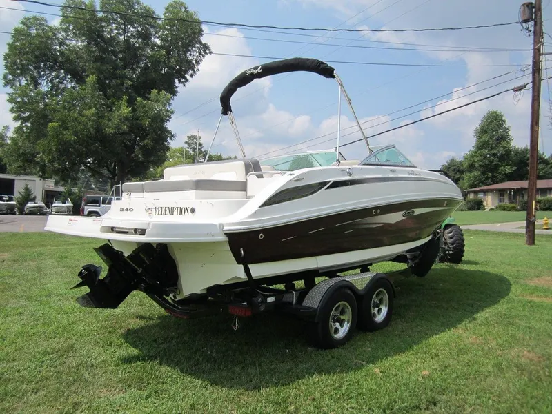Slide: The Image of 2012 Sea Ray 240 Sundeck on trailer, parked on grass. - 4