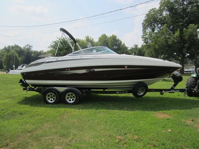 Slide: The Image of 2012 Sea Ray 240 Sundeck boat on trailer outdoors. - 5