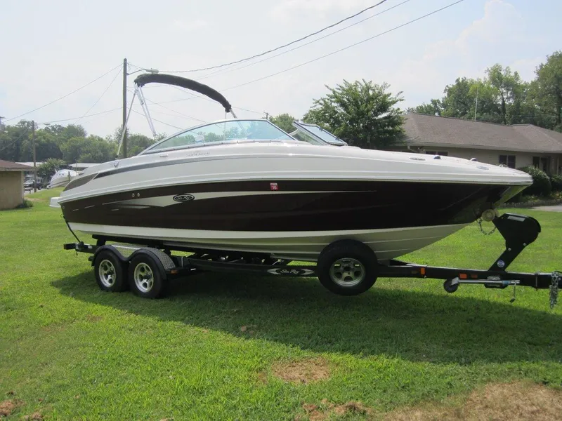 Slide: The Image of 2012 Sea Ray 240 Sundeck boat on trailer outdoors. - 6