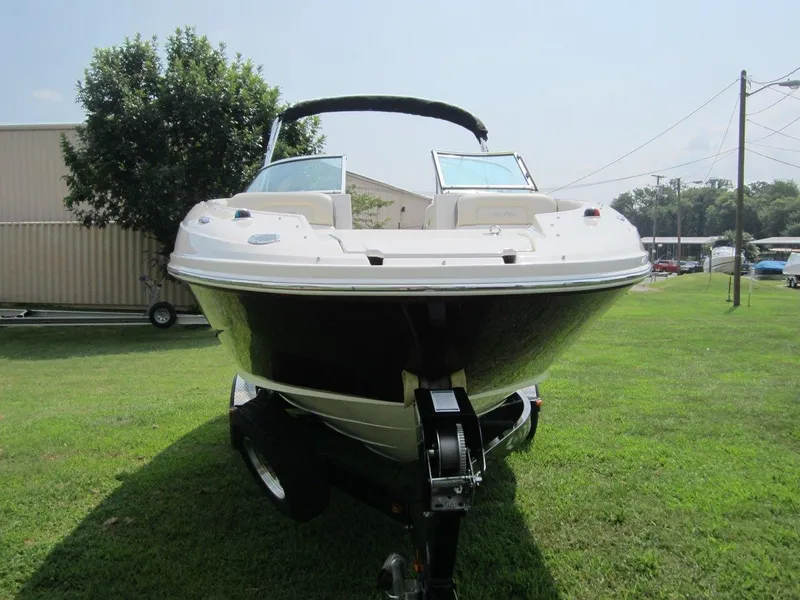 Slide: The Image of 2012 Sea Ray 240 Sundeck boat parked on grass. - 7