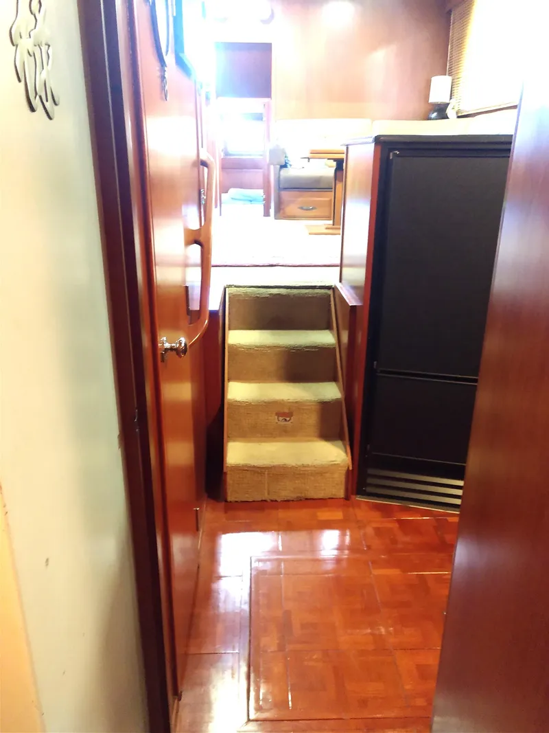 Slide: The Image of Interior view of 1981 Tollycraft 43 Motoryacht with wooden flooring and carpeted stairs. - 11