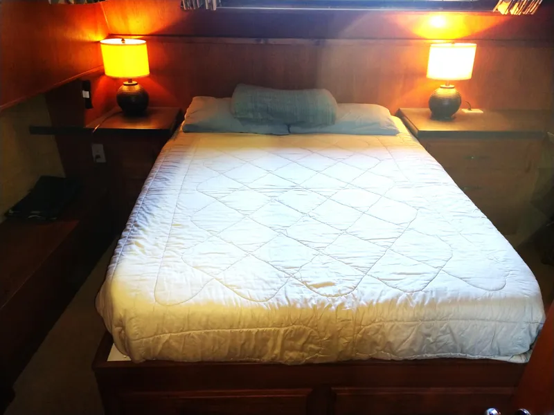 Slide: The Image of Cozy bedroom in 1981 Tollycraft 43 Motoryacht with double bed and warm lighting. - 24