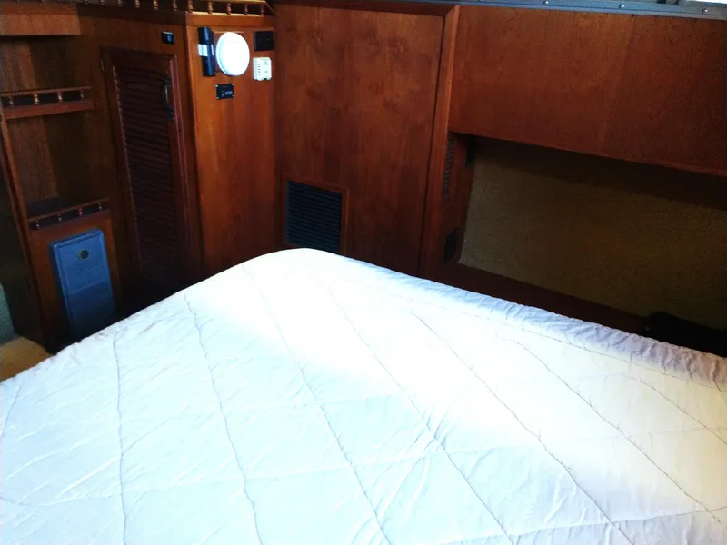 Slide: The Image of Interior cabin of 1981 Tollycraft 43 Motoryacht with wooden paneling and bed. - 27