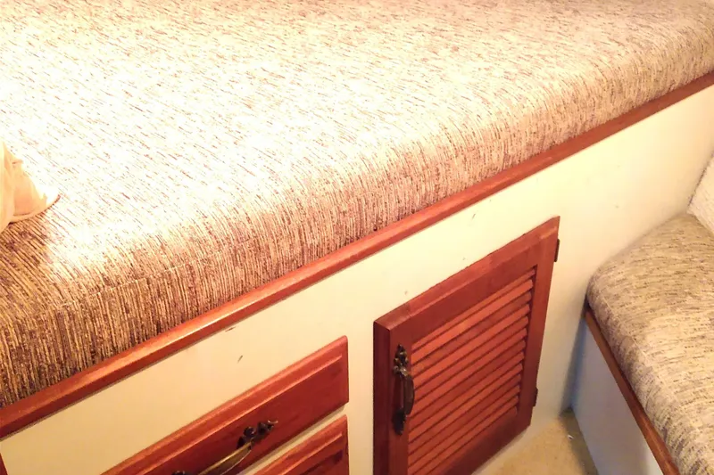 Slide: The Image of 1981 Tollycraft 43 Motoryacht interior with wooden cabinets and upholstered seating. - 33