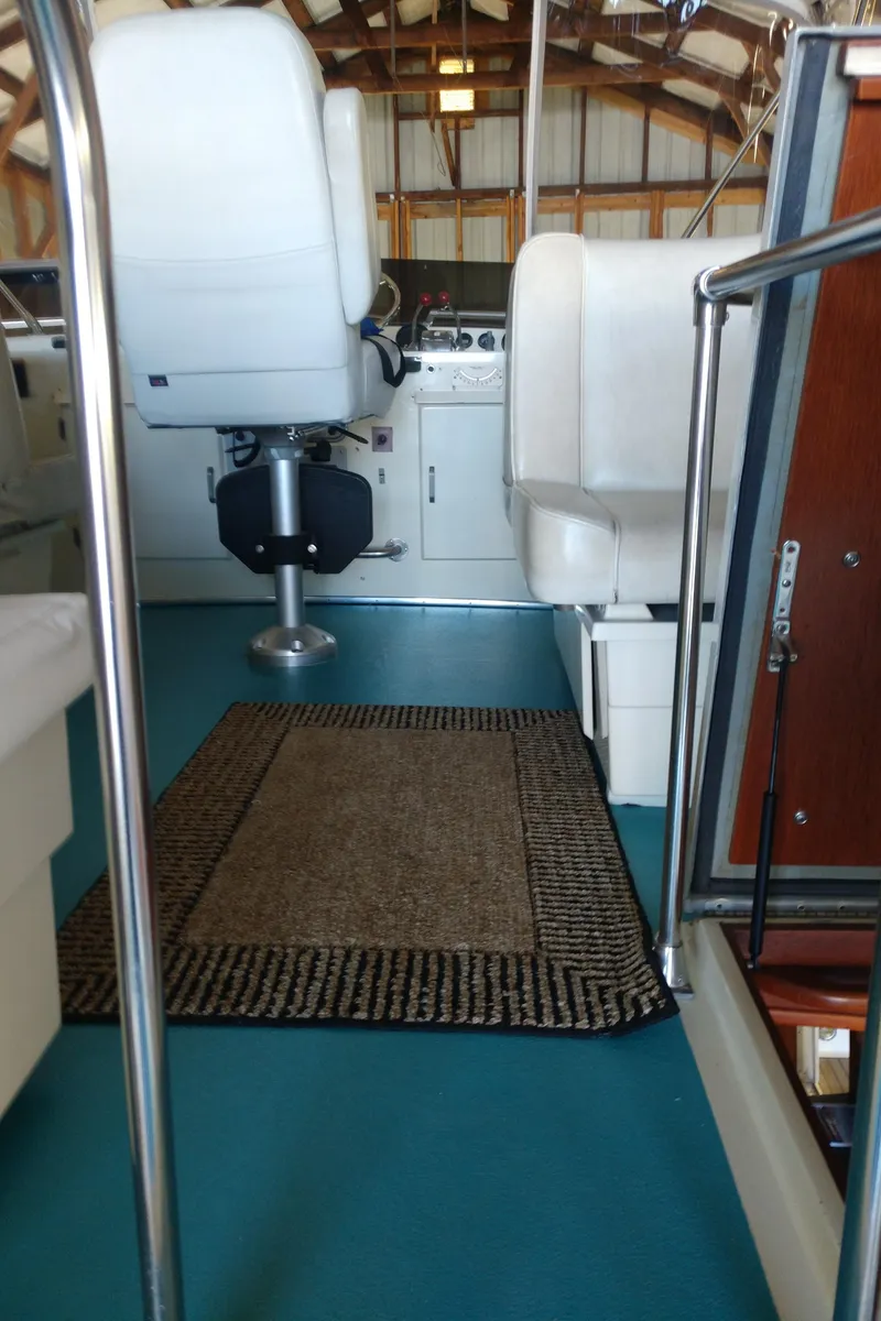 Slide: The Image of 1981 Tollycraft 43 Motoryacht interior with seating, steering, and carpeted floor. - 39