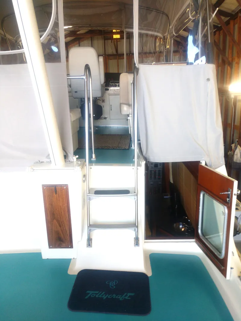 Slide: The Image of 1981 Tollycraft 43 Motoryacht interior with teal flooring and ladder to upper deck. - 40