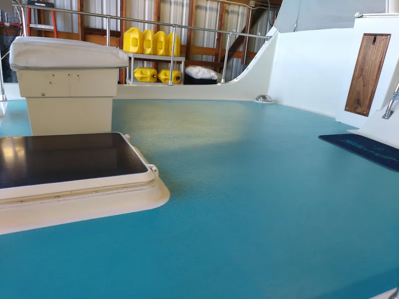 Slide: The Image of 1981 Tollycraft 43 Motoryacht deck with blue flooring and storage compartments. - 41