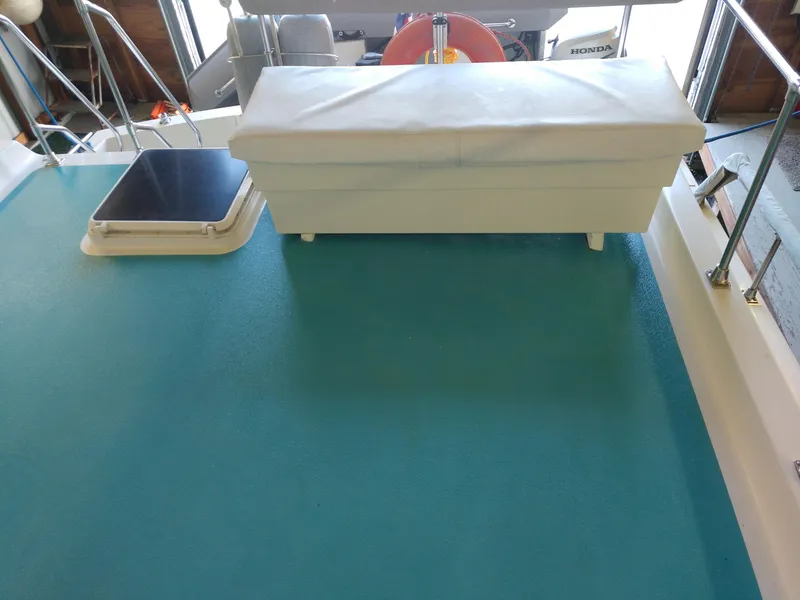 Slide: The Image of 1981 Tollycraft 43 Motoryacht deck with white bench and blue flooring. - 42