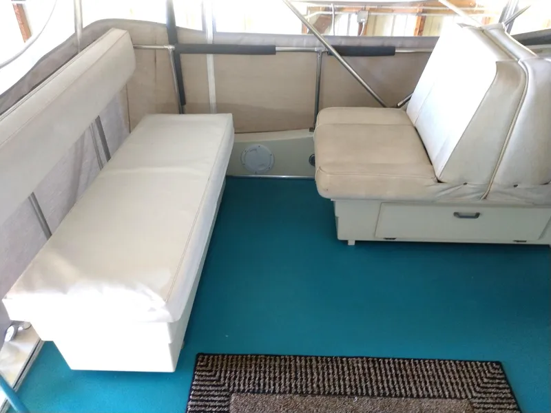 Slide: The Image of Interior of 1981 Tollycraft 43 Motoryacht with white seating and blue carpet. - 44