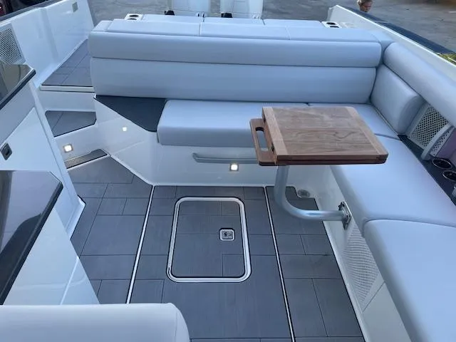 Slide: The Image of 2022 Aviara AV 32-OB boat interior with sleek seating and wooden table. - 19