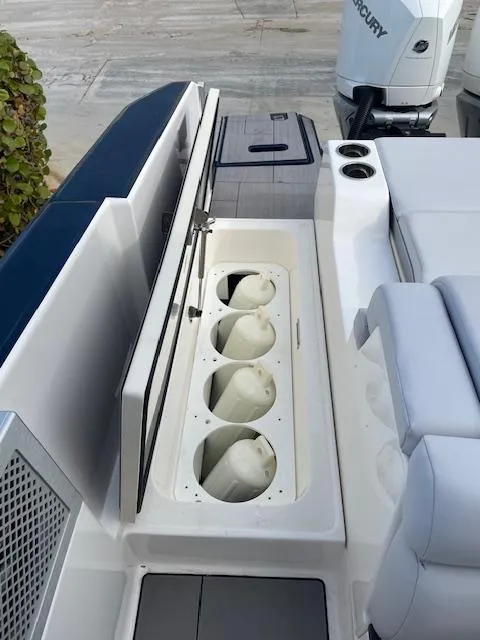 Slide: The Image of 2022 Aviara AV 32-OB boat with open storage compartment and Mercury outboard motor. - 30