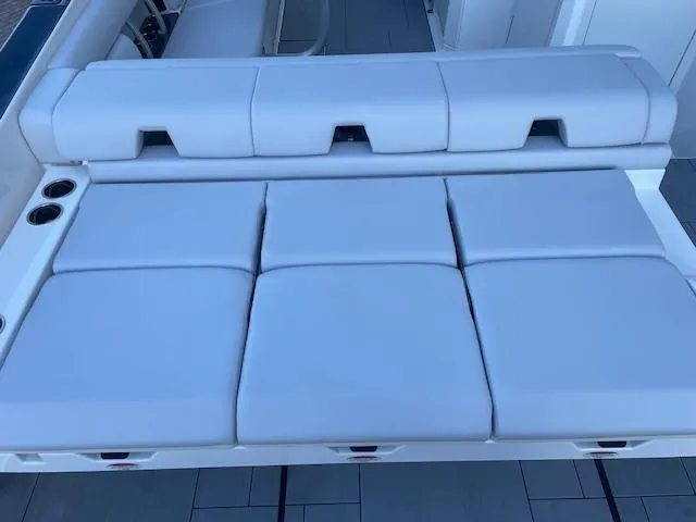 Slide: The Image of 2022 Aviara AV 32-OB boat seating, featuring luxurious white cushions and cup holders. - 32