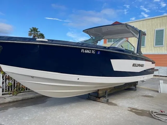 The Image of 2022 Aviara AV 32-OB boat on display, blue hull, docked outdoors. - 0