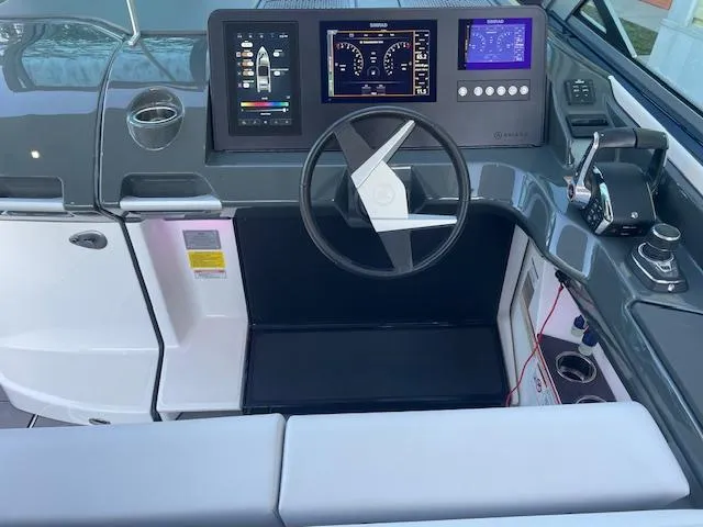 Slide: The Image of 2022 Aviara AV 32-OB boat dashboard with modern controls and steering wheel. - 11