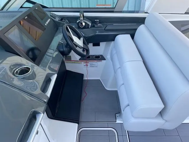 Slide: The Image of 2022 Aviara AV 32-OB boat cockpit with modern steering and seating. - 12