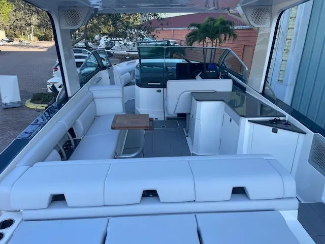 Slide: The Image of 2022 Aviara AV 32-OB boat interior with white seating and wooden table. - 13