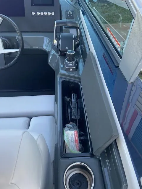 Slide: The Image of 2022 Aviara AV 32-OB boat interior with steering wheel and storage compartment. - 14