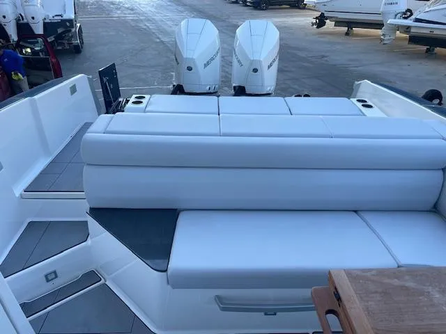 Slide: The Image of 2022 Aviara AV 32-OB boat with dual outboard motors and spacious seating area. - 17