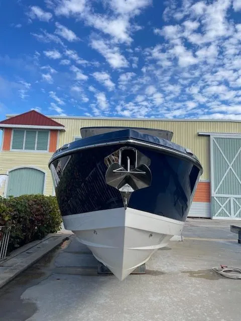 Slide: The Image of 2022 Aviara AV 32-OB boat docked, front view, under a blue sky. - 2