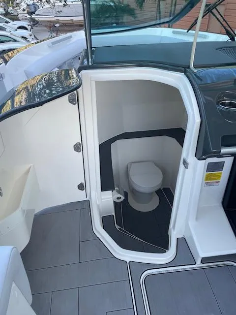Slide: The Image of 2022 Aviara AV 32-OB boat interior with compact marine toilet. - 29
