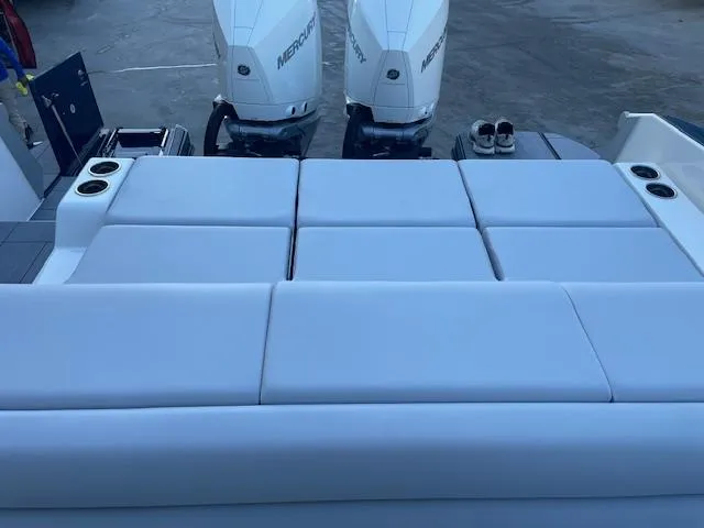 Slide: The Image of 2022 Aviara AV 32-OB boat with cushioned seating and dual Mercury outboard engines. - 31