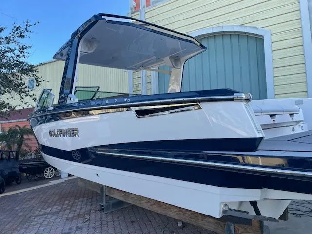 Slide: The Image of 2022 Aviara AV 32-OB boat, sleek design, docked outdoors. - 4