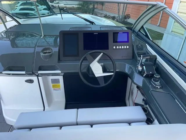 Slide: The Image of 2022 Aviara AV 32-OB boat helm with modern controls and sleek design. - 9