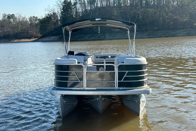Slide: The Image of 2022 Godfrey Sweetwater 2286 C pontoon boat on a calm lake. - 10