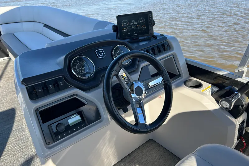 Slide: The Image of 2022 Godfrey Sweetwater 2286 C boat dashboard with steering wheel and controls. - 11