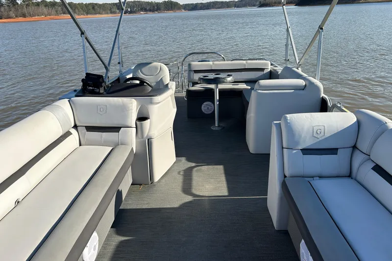 Slide: The Image of 2022 Godfrey Sweetwater 2286 C pontoon boat interior on a calm lake. - 13
