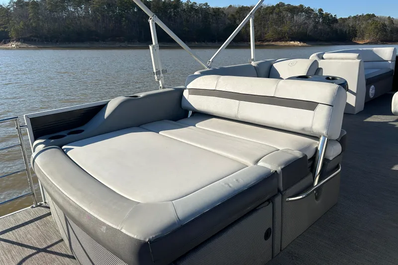 Slide: The Image of 2022 Godfrey Sweetwater 2286 C pontoon boat with comfortable seating on a serene lake. - 15