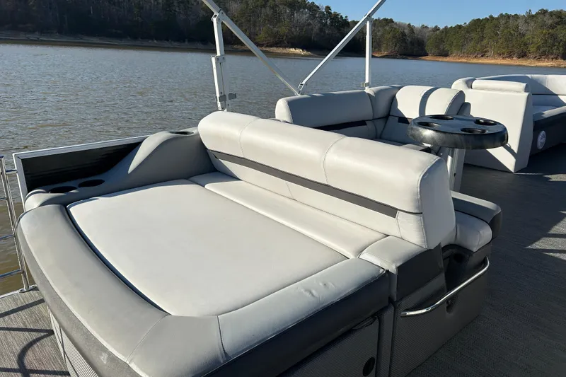 Slide: The Image of 2022 Godfrey Sweetwater 2286 C pontoon boat with comfortable seating on a serene lake. - 16